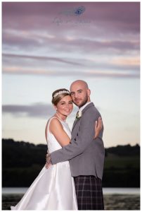 Lochside wedding photo newly married couple at sunset Life in Focus Portraits wedding photographer Rhu Helensburgh Gare Loch
