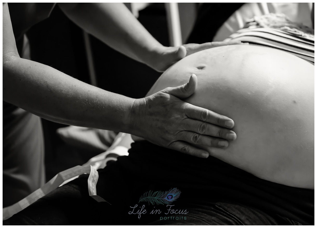 Midwife examining bump prior to c section birth Life in Focus Portraits birth photographer Cardross Dumbarton