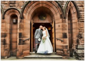 bride and groom kiss on church steps St Patrick's church Dumbarton Life in Focus Portraits wedding photography Dumbarton West Dunbartonshire