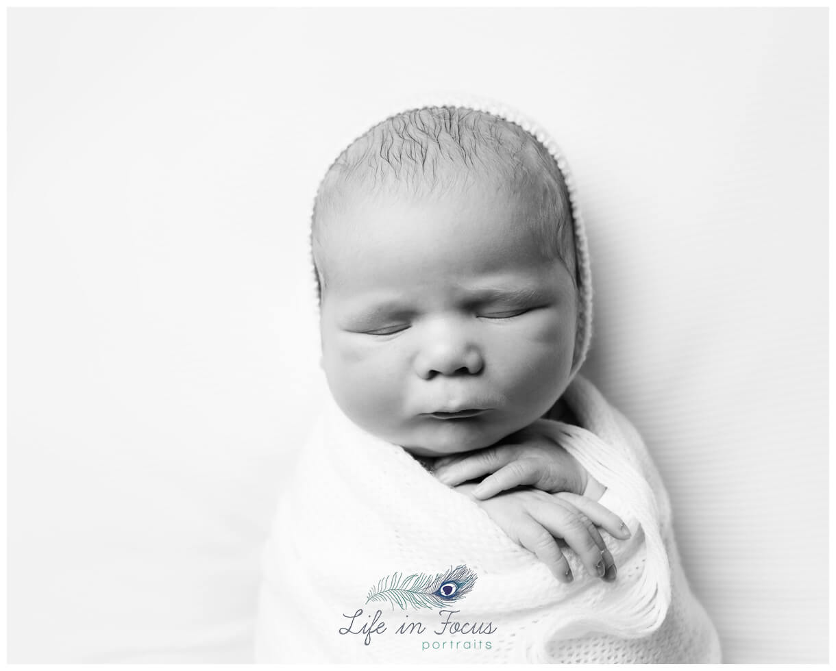 monochrome photo newborn baby wrapped in white Life in Focus Portraits Simply Baby newborn photos Rhu Helensburgh