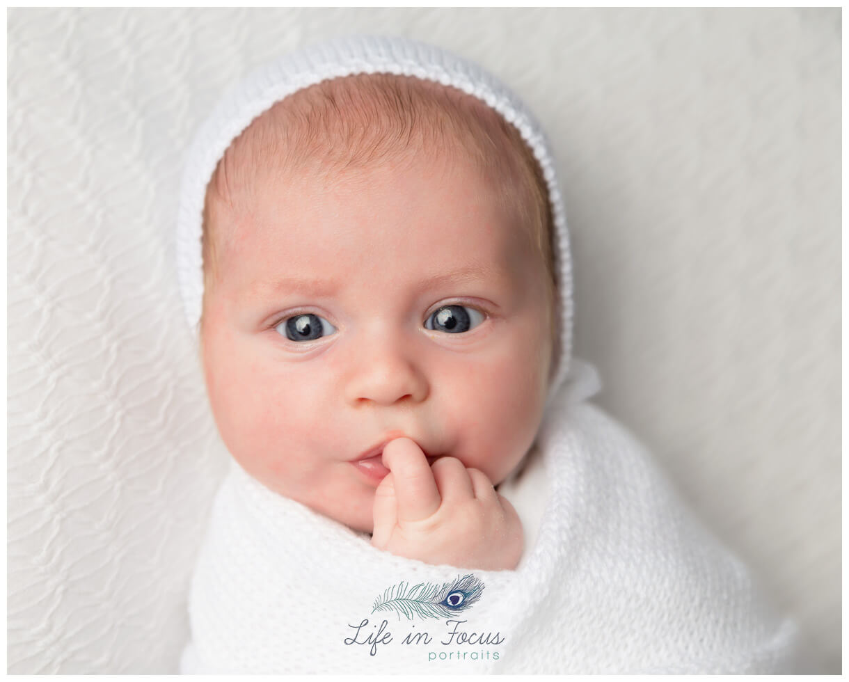 newborn baby in white bonnet Life in Focus Portraits Simply Baby newborn photography sessions Rhu Helensburgh