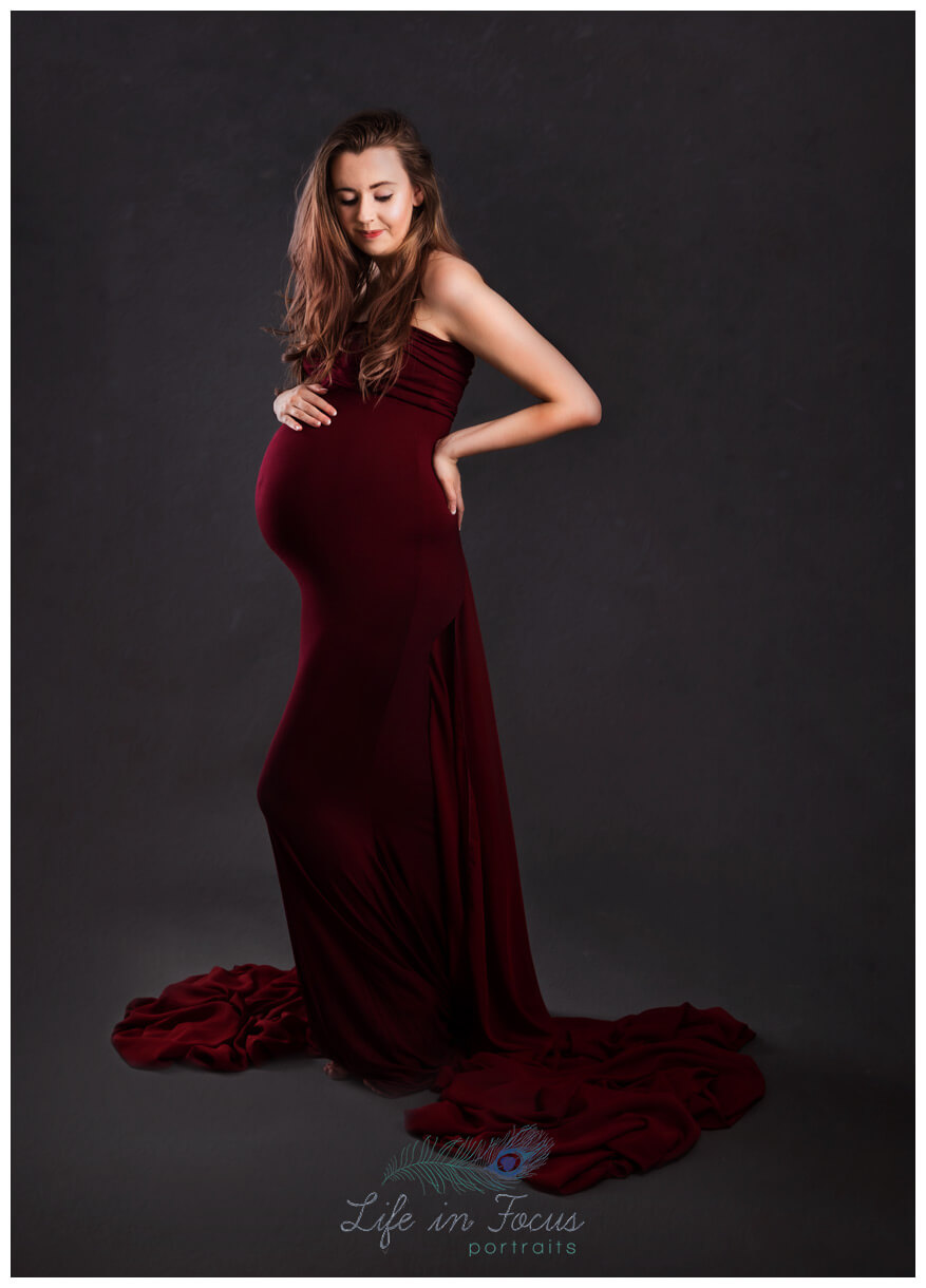 pregnant woman in long red dress Bespoke Maternity photo session Life in Focus Portraits pregnancy photoshoots Garelochead Rosneath Cove