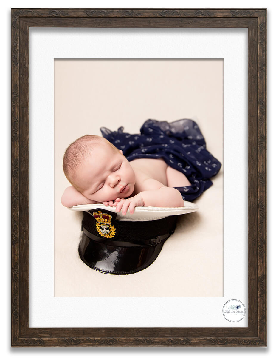 Royal Navy newborn baby on daddys cap Life in Focus Portraits newborn baby photography studio Rhu Helensburgh Argyll and Bute