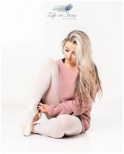 ballet dancer in warm up fastening pointe shoes Life in Focus Portraits ballet dance photographer Helensburgh