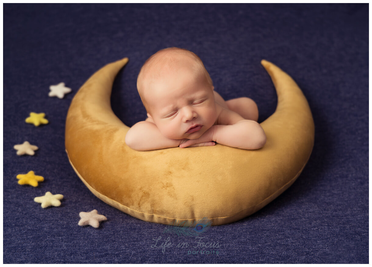 photo of newborn baby boy posed on moon pillow with stars Life in Focus Portraits specialist newborn photographer Rhu Helensburgh