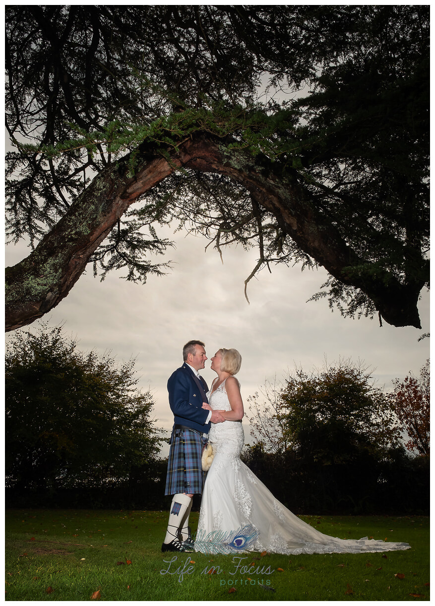 bride and groom portrait under tree wedding photo Helensburgh