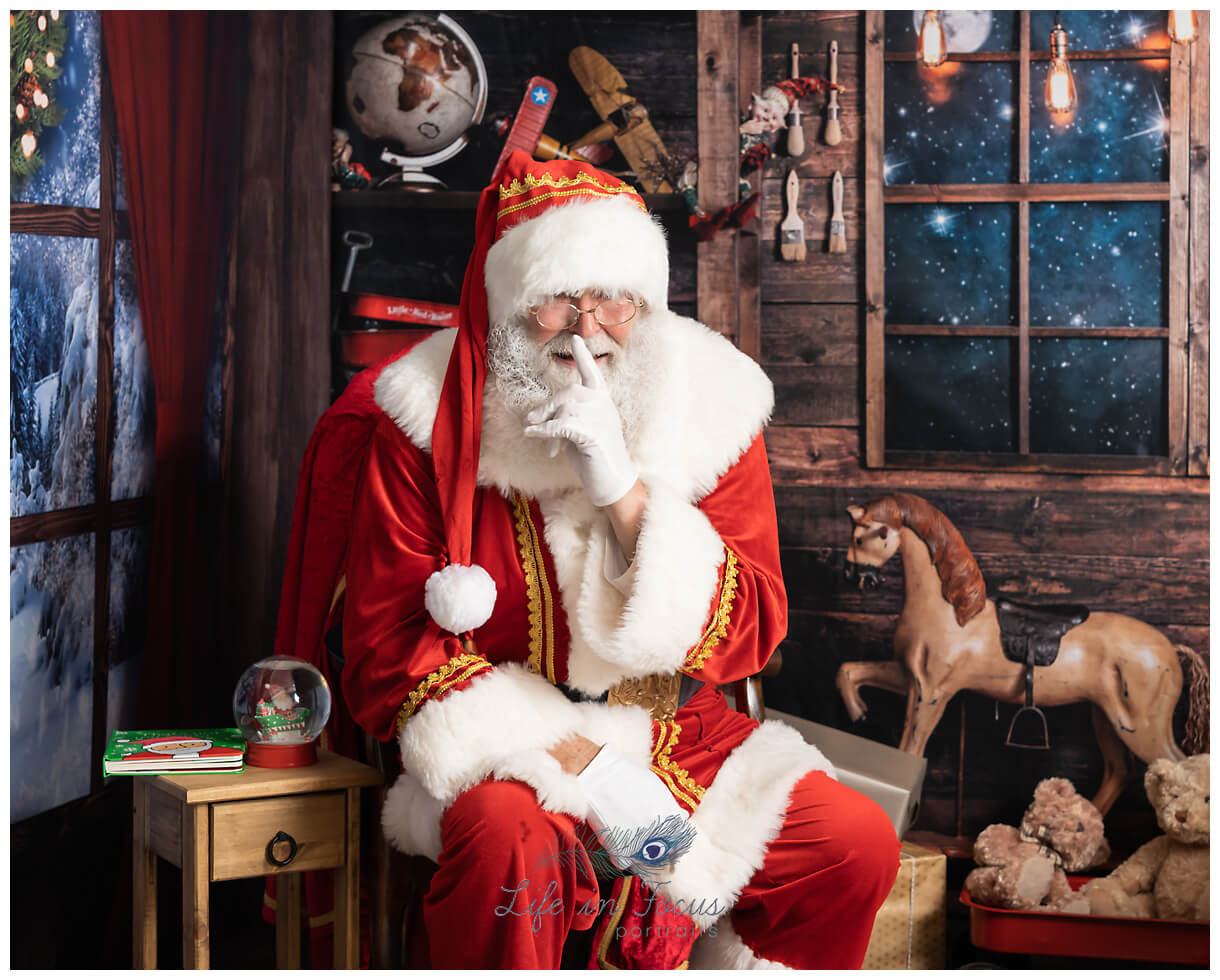 Santa says Shhhh The Santa Experience Life in Focus Portraits photo of santa saying shhh santa photo sessions Life in Focus Portraits photography studio Rhu Helensburgh