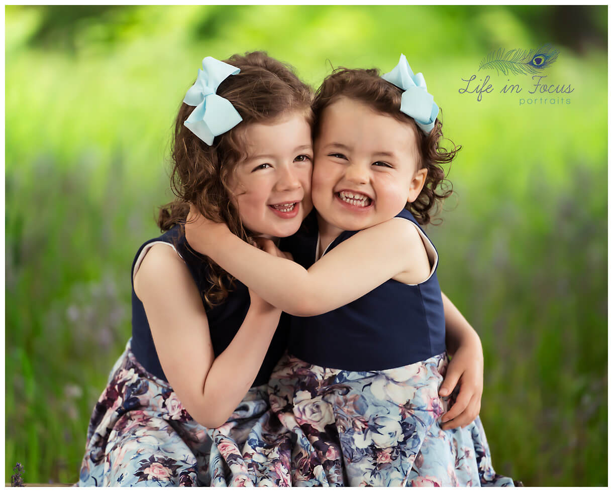 photo of 2 little girls hugging and smiling outdoor family photos Cardross