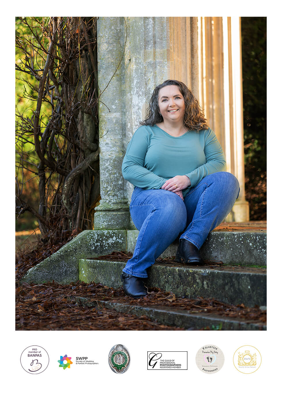 Outdoor photo of female photographer smiling to camera near Loch Lomond